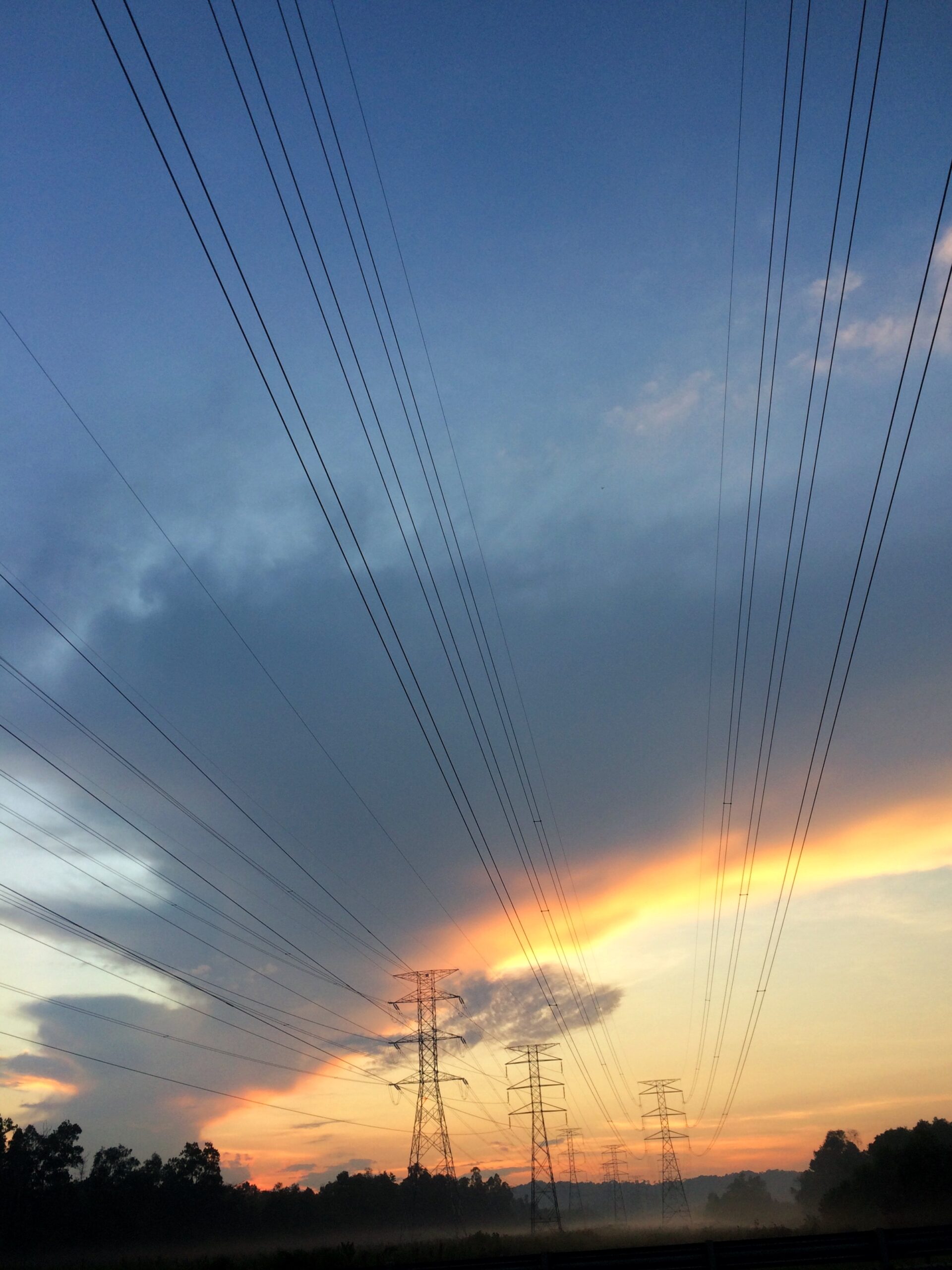 Electrical lines against sunset