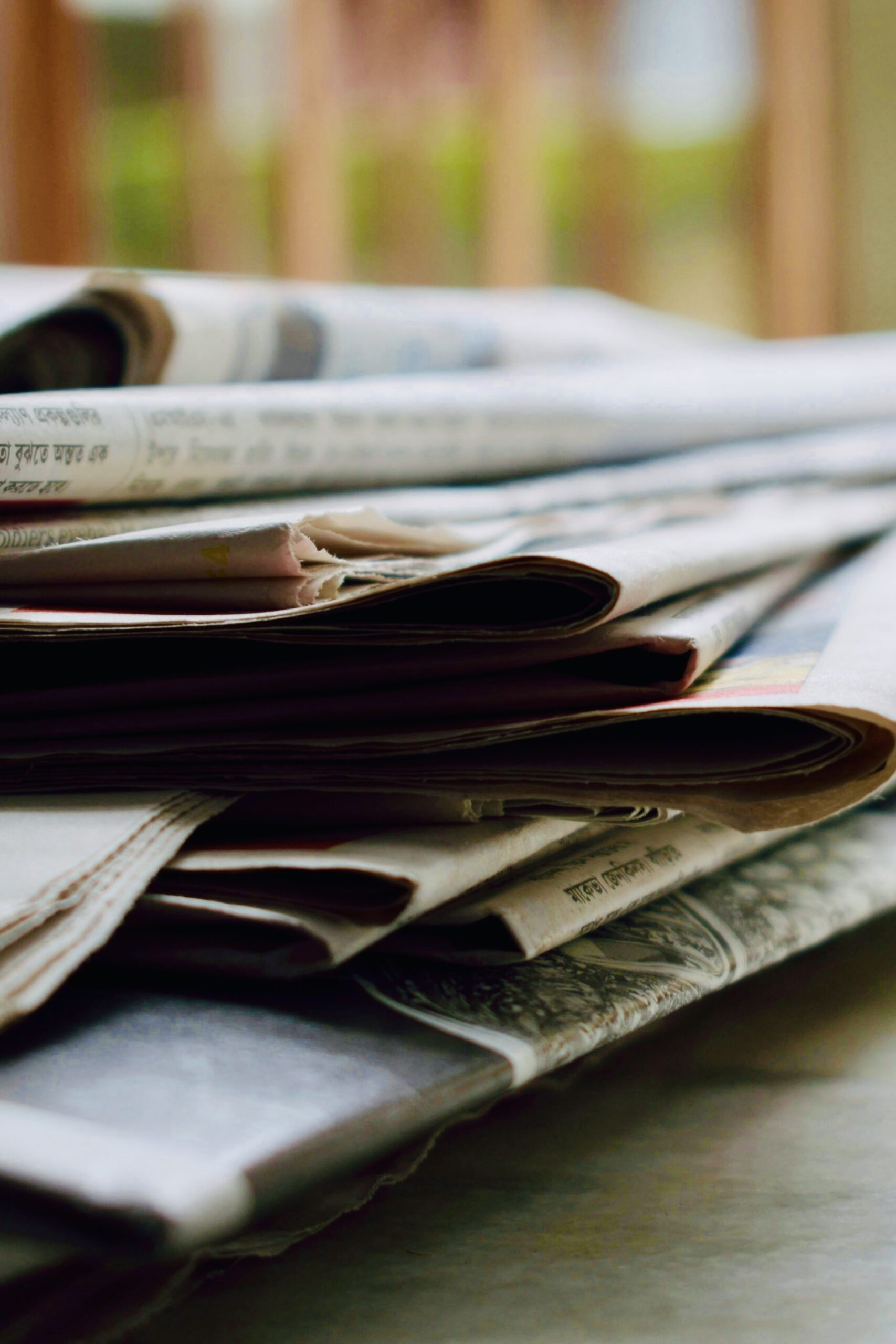 Stack of newspapers on table